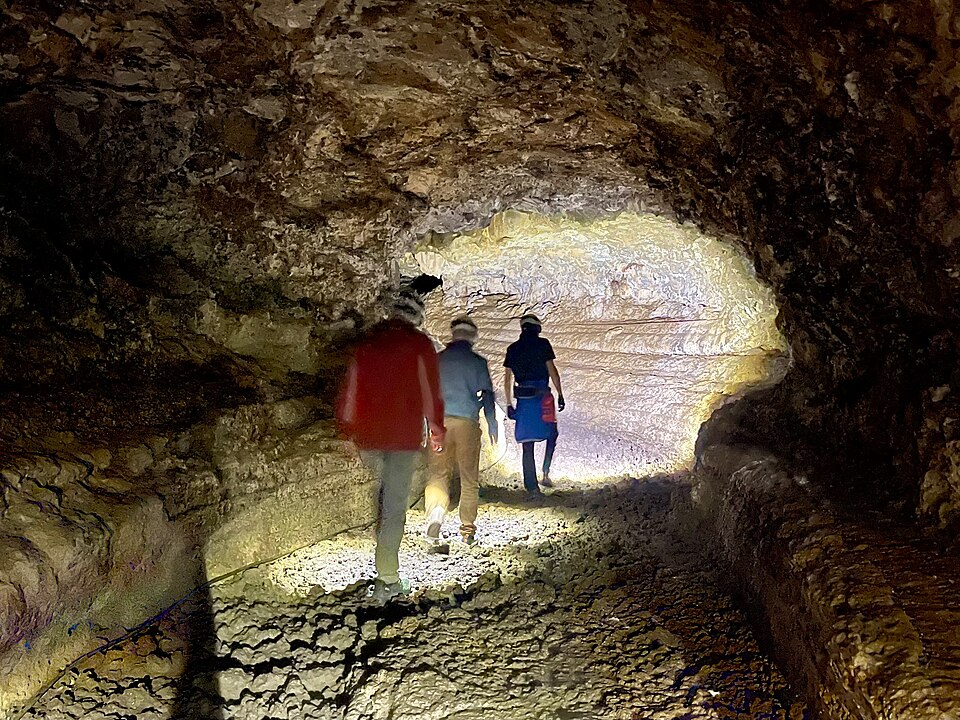 A tour group with helmets inside the lava tube