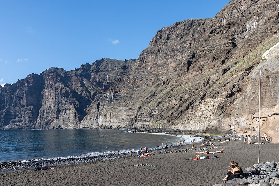 Playa de los Guíos below the Los Gigantes cliffs, with the safety nets on the slope